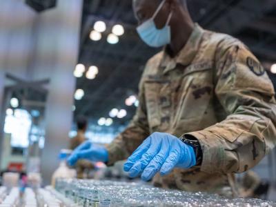 Guardsman with rows of vaccine vials