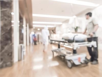 Gurney in hospital corridor blurred