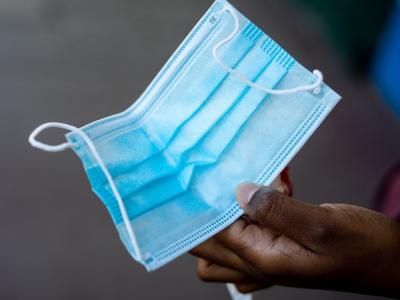 Hand holding surgical mask