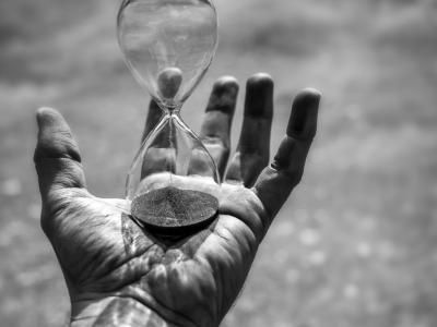 Hand holding an hourglass
