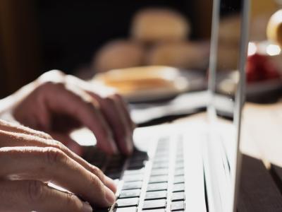 Hands typing on laptop computer