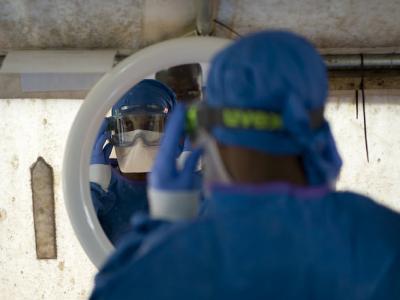 Health worker donning PPE