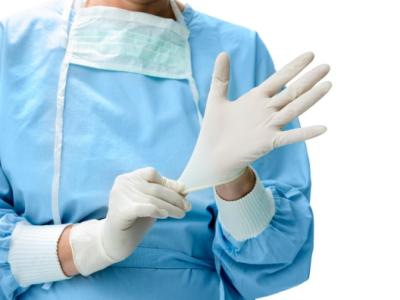 Health worker donning gloves