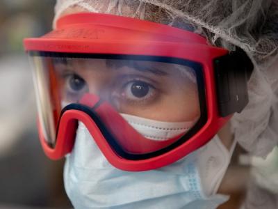 Healthcare worker wearing goggles and masks