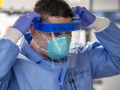Health worker with respirator and face shield