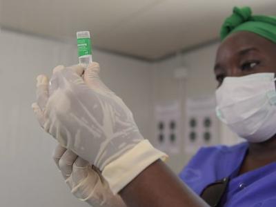 Health worker holding COVID-19 vaccine vial