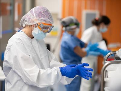 Health workers putting on protective equipment