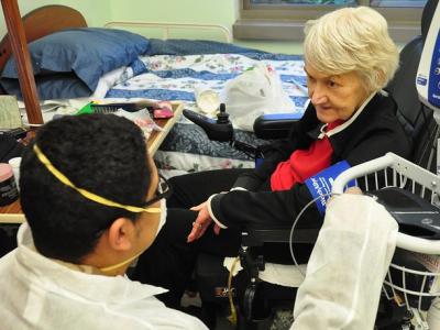 Health worker with resident of nursing home