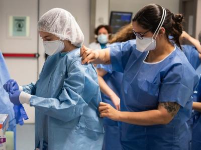 Healthcare workers donning protective equipment