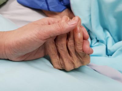Holding older patient's hand
