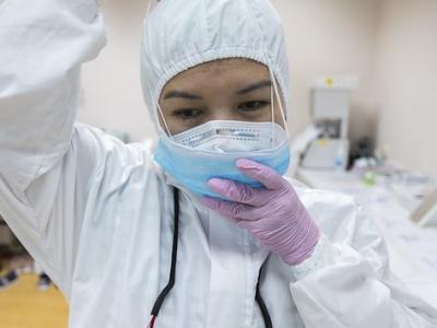 Indonesian healthcare worker donning PPE