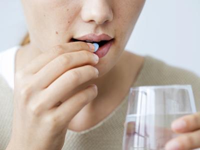 Woman taking pill
