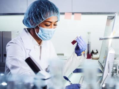 Lab researcher with sample