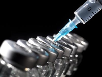 Lineaup of vaccine vials with syringe