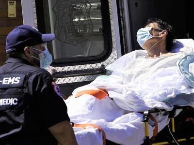 Loading a COVID-19 patient onto an ambulance