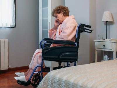 Lonely woman in nursing home wheelchair