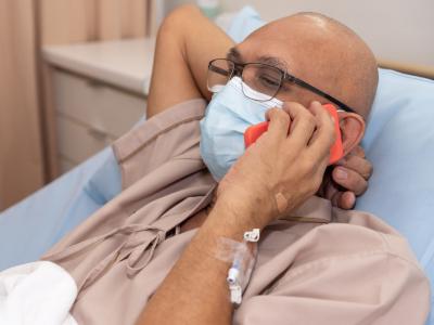 Male cancer patient talking on phone
