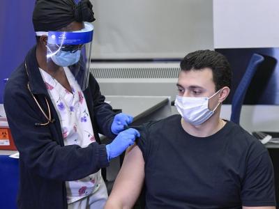 Man getting prepped for COVID vaccine