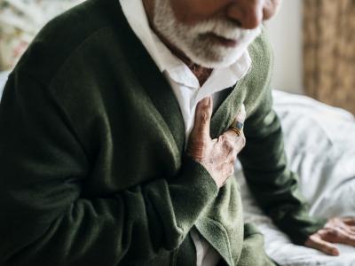 Man having heart attack holding chest