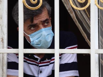 Man quarantined looking out window