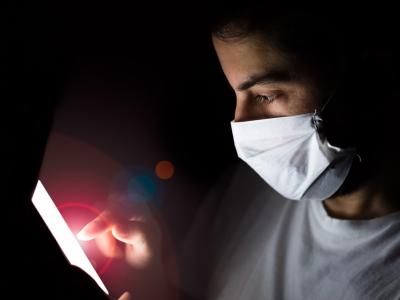 Man using smartphone at night