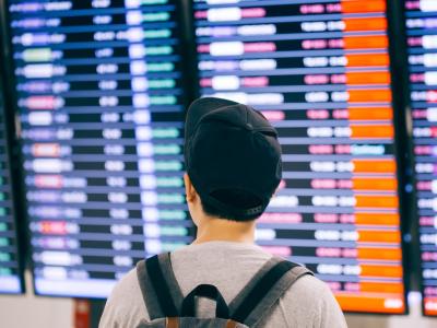 Man viewing airport flight board