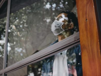 Man wearing mask in window