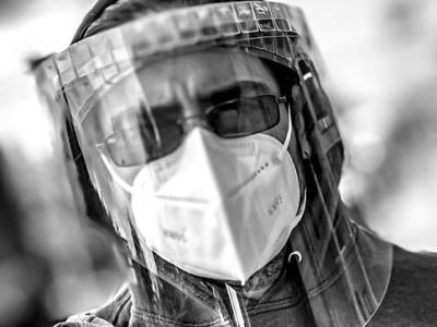 Man wearing respirator, face shield