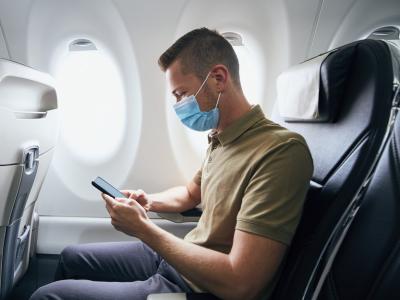 Man wearing surgical mask on plane