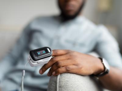 Man with pulse oximeter on finger