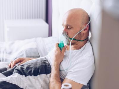 Man with oxygen mask in hospital