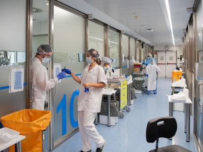 Mask-wearing health workers in hospital hallway