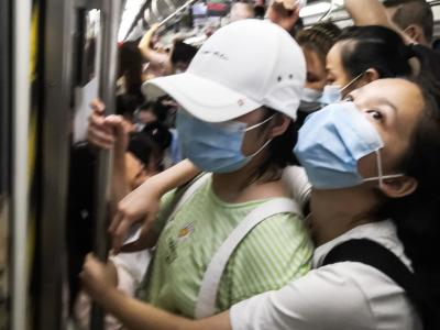 Masked people in a crowded subway