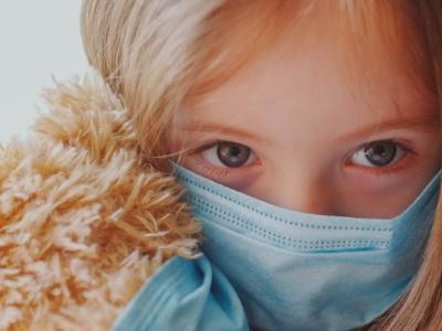 Masked girl with masked teddy bear