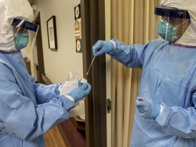Medics handling a swab