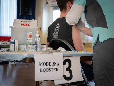 Moderna booster sign in vaccine clinic