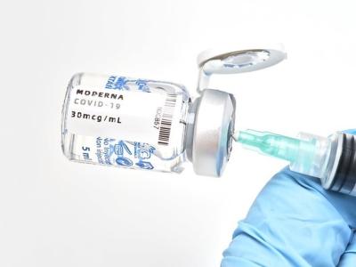 Sideways Moderna vaccine vial and syringe