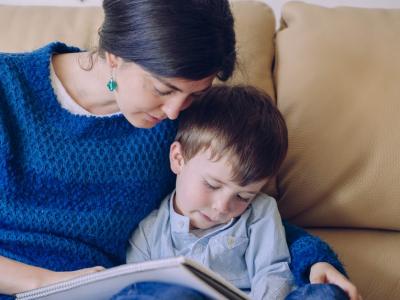 Mother reading to sick boy