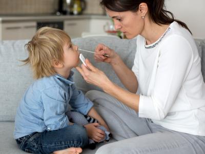 Mother swabbing child for rapid COVID-19 test