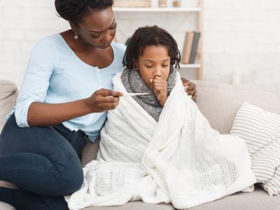 Mother taking daughter's temperature