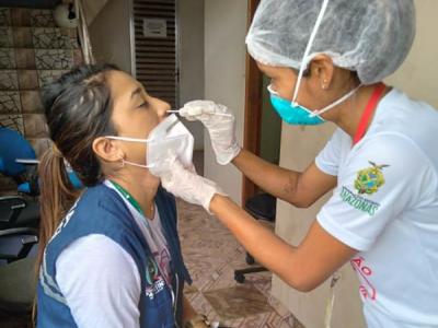 Health worker getting nasal swab