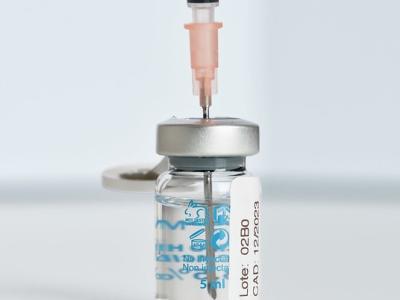 Needle inserted into Pfizer COVID vaccine vial