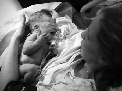 Newborn with mom and umbilical cord clamp