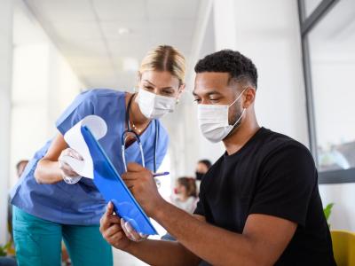 Nurse counseling man on vaccines