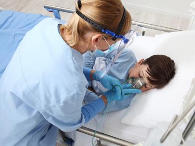 Nurse giving oxygen to sick boy