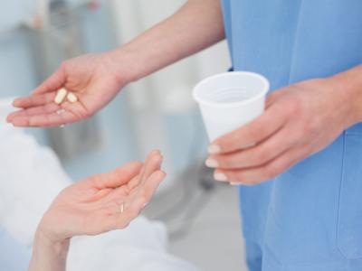 Nurse giving pills