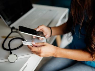 Nurse with smartphone and COVID test