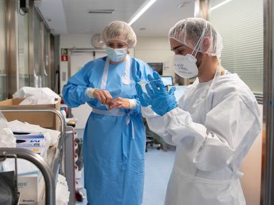 Nurses putting on protective equipment