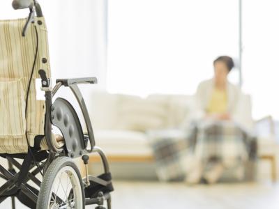 Nursing home patient, blurred, and empty wheelchair