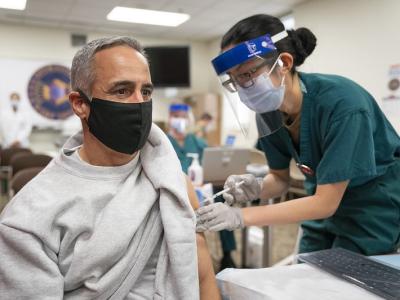 Older man receiving COVID-19 vaccine